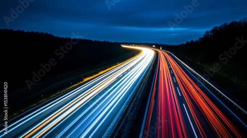 A modern highway illuminated by bright streetlights, stretching into the distance, with the glow of the lights reflecting off the road at night.