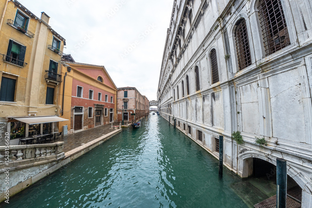 Naklejka premium Gondola navigating picturesque canal in venice, italy
