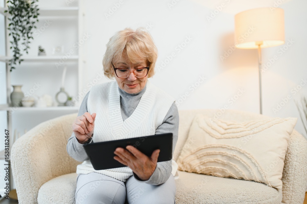 Old happy woman having a video call with her family on a tablet Old happy woman having a video call with her family on a tablet