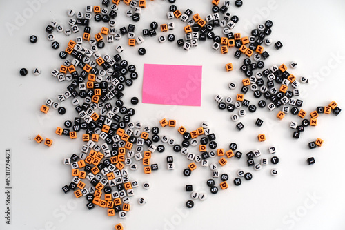 Photography A piece of pink paper surrounded by a scattered assortment of letters and number
