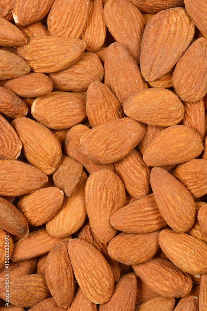 A close-up, top-down shot of a pile of raw almonds, showcasing their natural texture and color. A close-up, top-down shot of a pile of raw almonds, showcasing their natural texture and color.