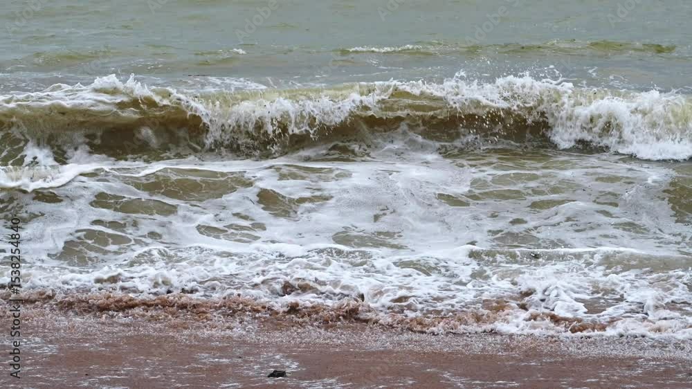 dirty water and big waves at sea during monsoon season on sandy beach. Slow motion dirty water and big waves at sea during monsoon season on sandy beach. Slow motion