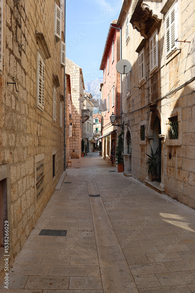 Obraz premium Picturesque Mediterranean street in coastal town Makarska, Croatia. Makarska is popular summer travel destination.