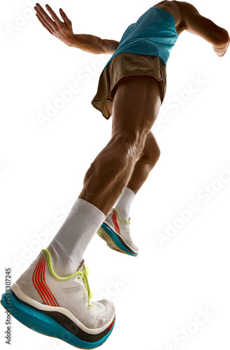 Muscular runner in blue singlet and brown shorts performs forward sprint with intense stride and visible veins under dynamic lighting. Concept of dynamic posture analysis
