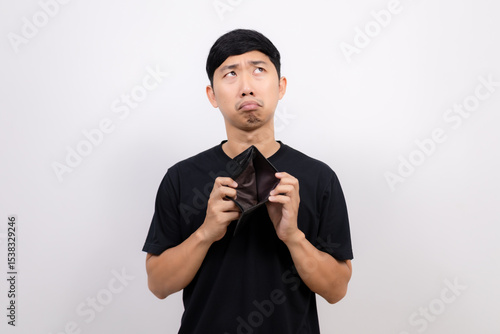 Asian man black shirt hold  no money wallet feel sad and looking up isolated