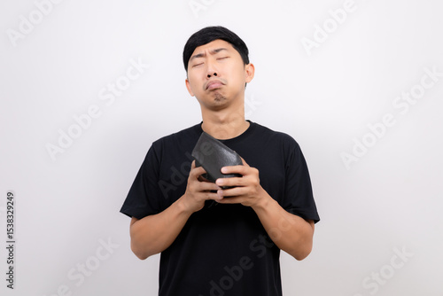 Asian man black shirt hold  no money wallet feel sad isolated