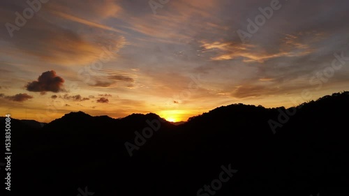 Wallpaper Mural breathtaking sunset over the ocean, painting the sky in vibrant orange, red, and purple hues above the silhouette of coastal buildings and anchored ships. Peaceful and cinematic Torontodigital.ca