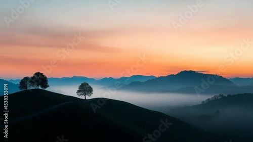 Wallpaper Mural A mountain range with a tree on top of a hill. The sky is a mix of orange and pink hues Torontodigital.ca
