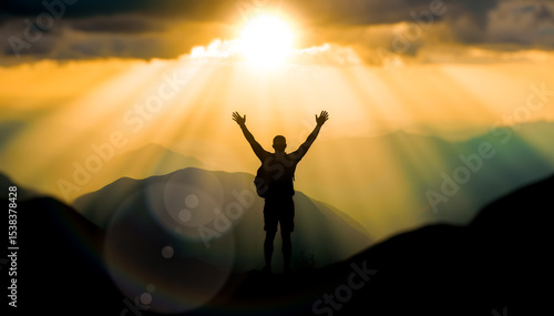 Fotografia Silhouette of man with arms raised on mountain top at sunrise, a concept for fre