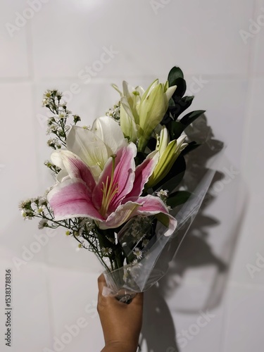 woman holding bouquet of fresh flowers lily pink and white