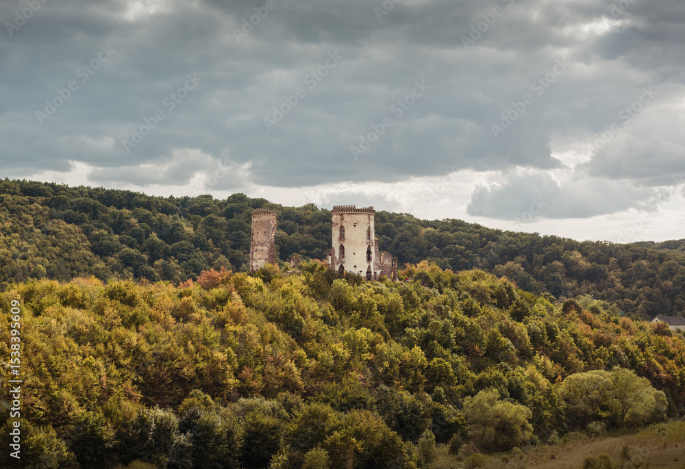 Chervonohorod Castle on a steep hill in the middle of the valley of the Dzhuryn river. Two tower ruins of abandoned castle near Nyrkiv, Ukraine. Chervonohorod Castle on a steep hill in the middle of the valley of the Dzhuryn river. Two tower ruins of abandoned castle near Nyrkiv, Ukraine.