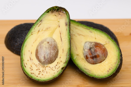 Quadro em tela Rotten avocado unfit for consumption, cut in half, not fresh