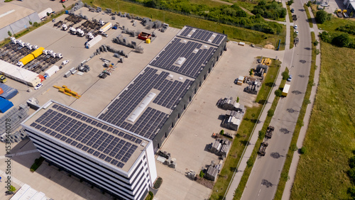 A large building with solar panels on the roof. Aerial view.