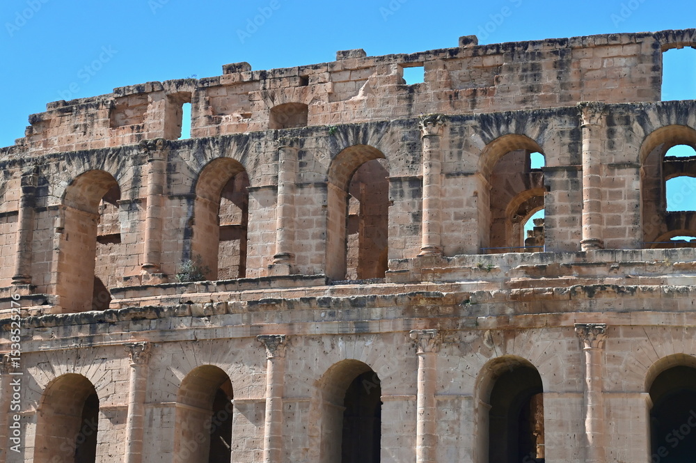 Obraz premium Architecture of El Jem Colosseum Showcasing Grand Arches, Strong Pillars, and Detailed Stonework from Roman Times