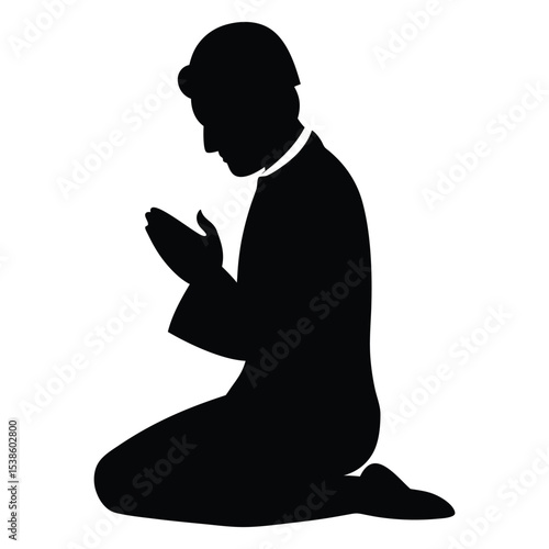 Silhouette of a person praying on their knees in devotion