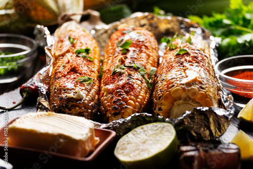 Wallpaper Mural Grilled Sweetcorn with smoked paprika lime and butter in tin foil on kitchen table gluten free healthy food background Torontodigital.ca