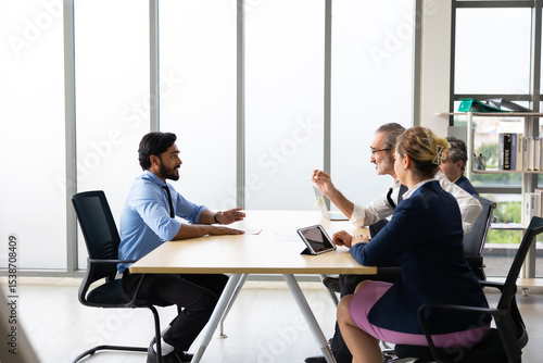 Human resources : company, successful deal. Human resources manager interviewing applicant at modern office.  Indian man candidate job interviewing and answering question hr CV recruiter