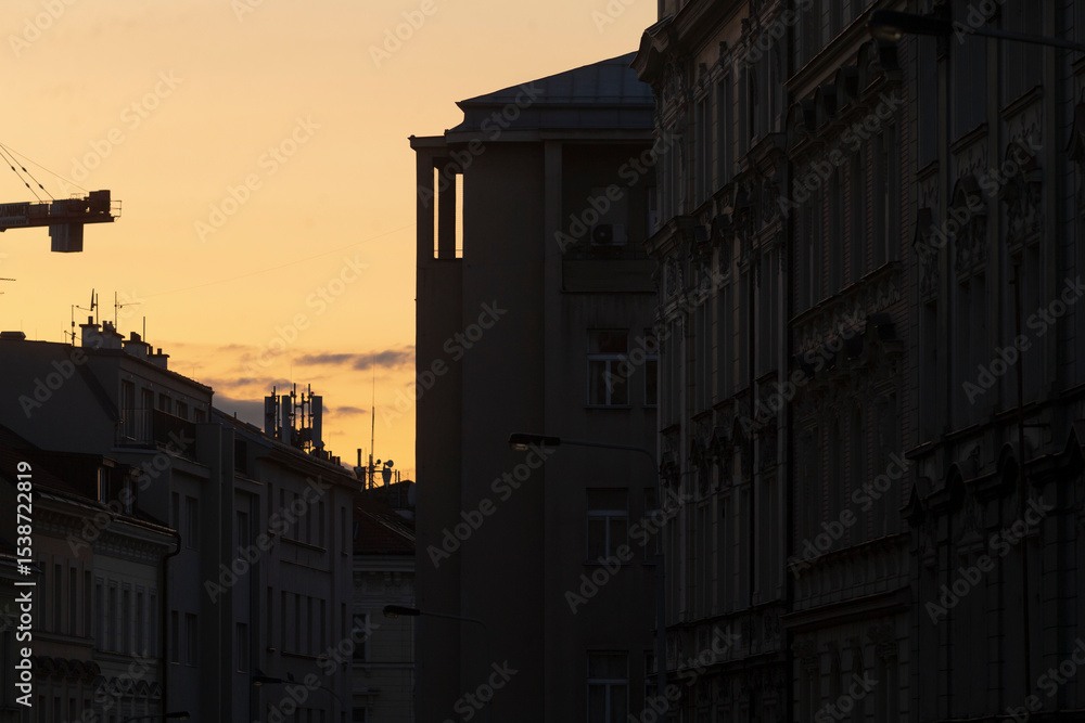 Silhouette of city buildings against a sunset sky, featuring a crane and detailed architecture. This urban scene captures constructions essence with a tranquil evening ambiance Silhouette of city buildings against a sunset sky, featuring a crane and detailed architecture. This urban scene captures constructions essence with a tranquil evening ambiance