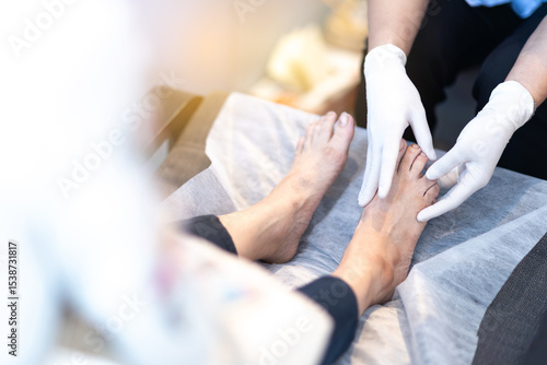 Nurse examining elderly patient feet healthcare podiatry medical checkup close up