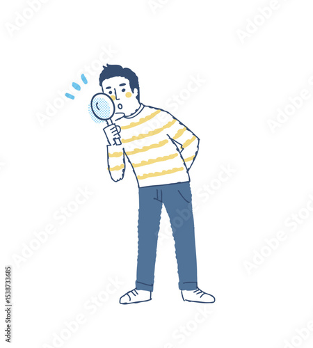 虫眼鏡を覗いている若い男性