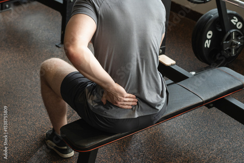 Photography Athlete or young man sitting with pain in lower back at gym with muscle tension