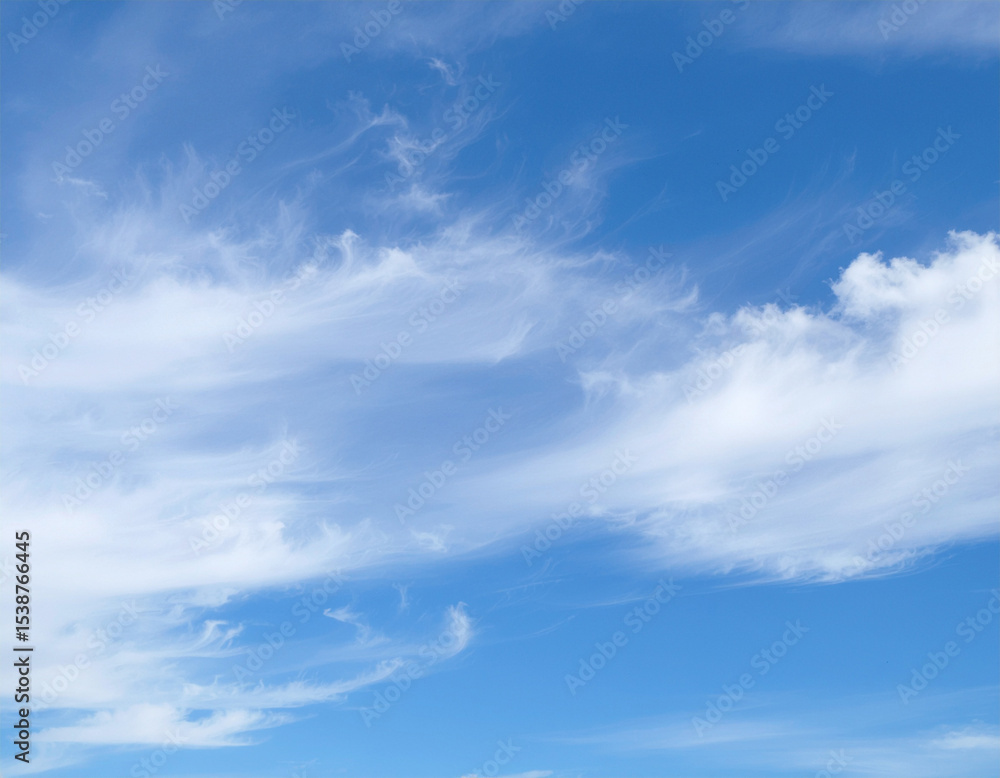 Obraz premium blue sky with light scattered white clouds