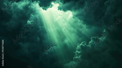 A beam of light shining through dark clouds with a green screen background  