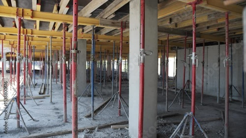 Concrete floor under construction with formwork and support props