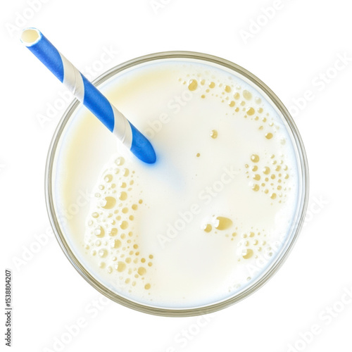 Overhead view of glass of milk with blue and white striped straw