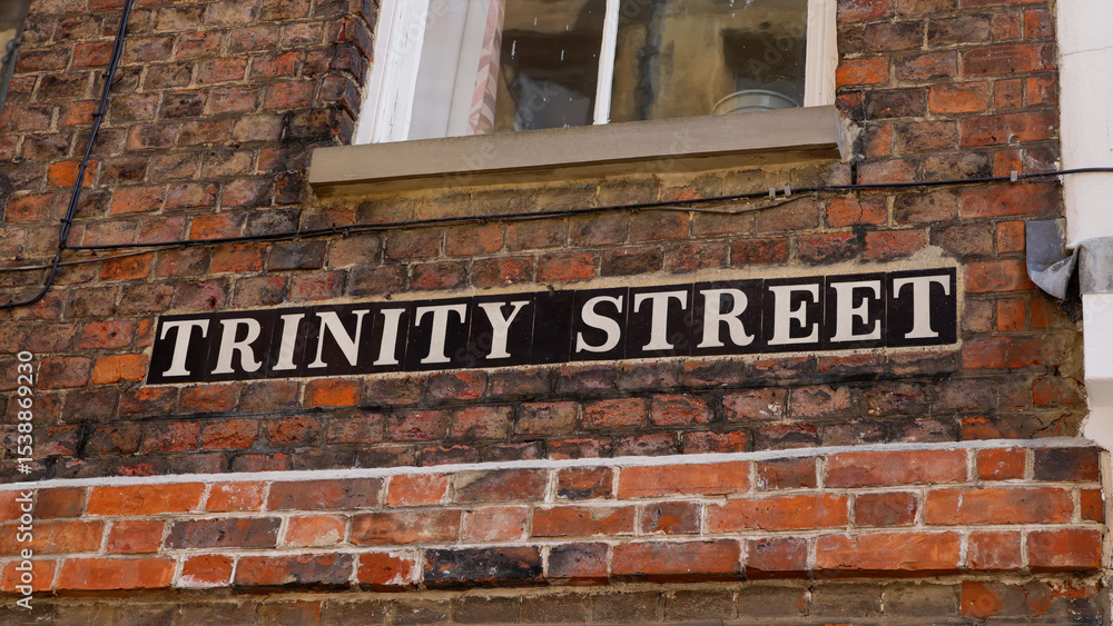 Obraz premium Trinity Street sign on a brick wall in Cambridge, UK, a historic and iconic street name