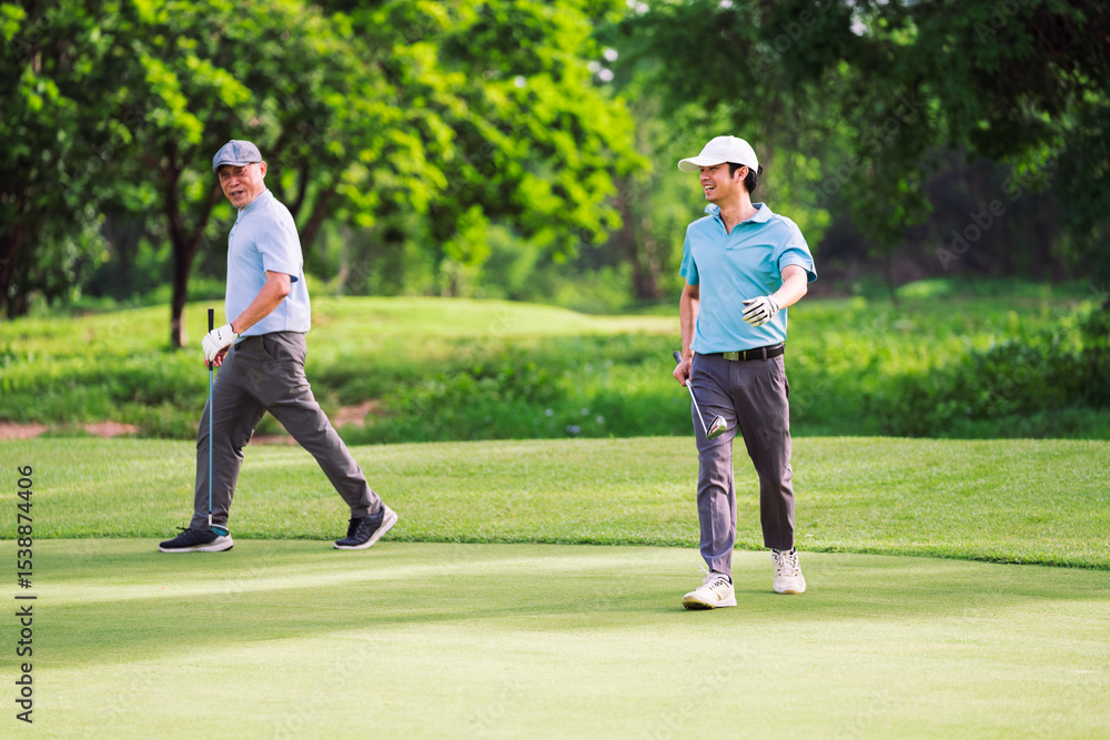 Fototapeta premium Happy family bonding moment between senior and young golfer during relaxing round of golf. Shared laughter, teamwork, and connection in nature.