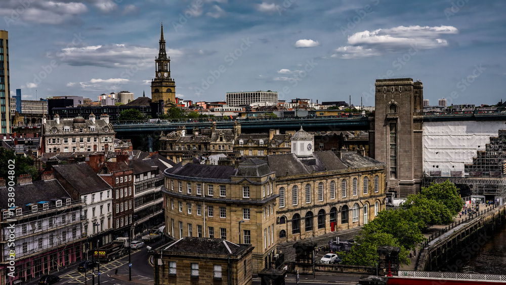 Fototapeta premium Newcastle upon Tyne cityscape showing All Saints' Church, Tyne Bridge and the Guildhall on a cloudy day