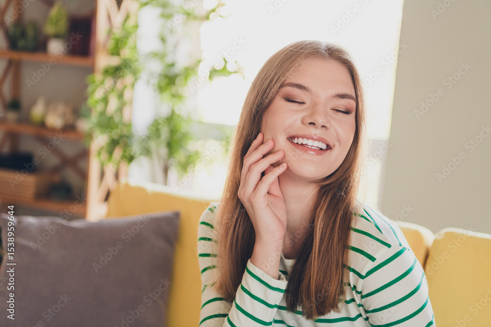 Fototapeta premium Charming Young Woman Smiling Joyfully in a Bright Home Interior with Daylight