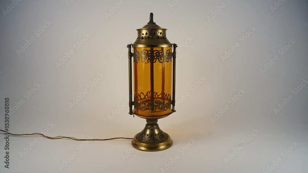 Antique brass table lamp with amber glass panels and decorative metal accents. Antique brass table lamp with amber glass panels and decorative metal accents.