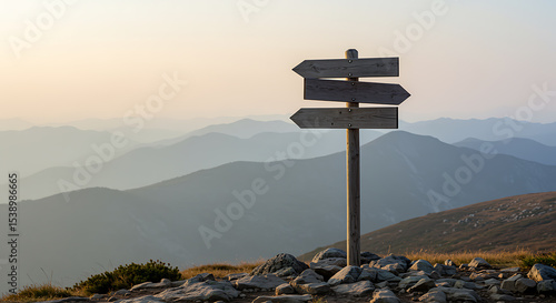 Wooden signpost on a mountain peak directing towards various directions in the landscape