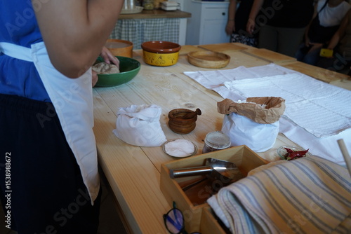 Fototapeta A traditional Greek kitchen scene preparing topia, a wartime survival food made by mothers during the Occupation—flour, salt, and simple tools recall resilience and cultural memory