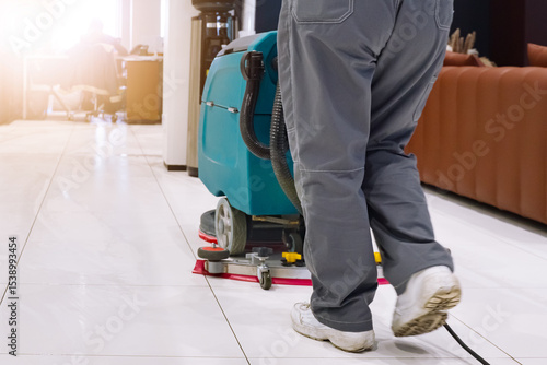 Tableau sur toile Office cleaning in progress with floor scrubber at midday in a modern workspace