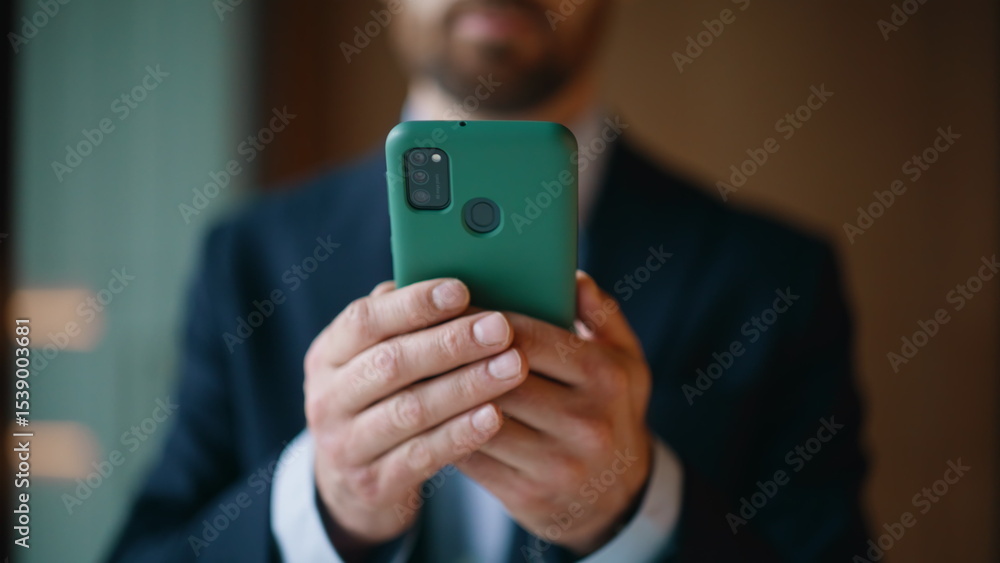 Executive hands holding mobile phone at company workspace closeup. Elegant man Executive hands holding mobile phone at company workspace closeup. Elegant man