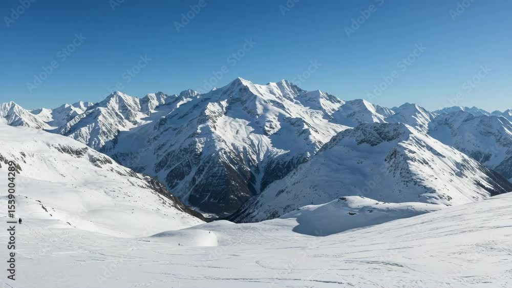 Snow-Covered Mountain Peaks with Blue Sky and Serene Atmosphere in Wide Natural Landscape Snow-Covered Mountain Peaks with Blue Sky and Serene Atmosphere in Wide Natural Landscape