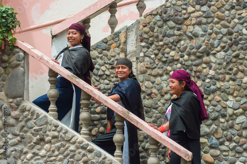 Indigenous women walking down stairs in traditional clothing