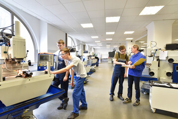 Group of young people in technical vocational training with teacher