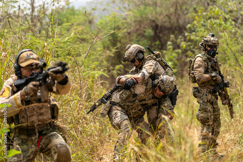 Fototapeta premium Soldier Carrying Injured Comrade During Tactical Combat Mission – Military Rescue Operation in Jungle, Armed Forces in Full Gear Providing Assistance Under Fire, Real Battlefield Scene