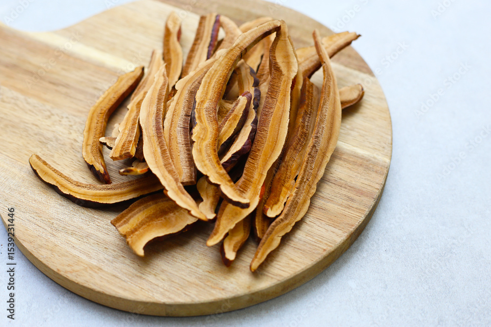 Fototapeta premium Dried slices of Ganoderma lucidum, also known as reishi mushroom, widely used in traditional medicine for its immune-boosting properties.