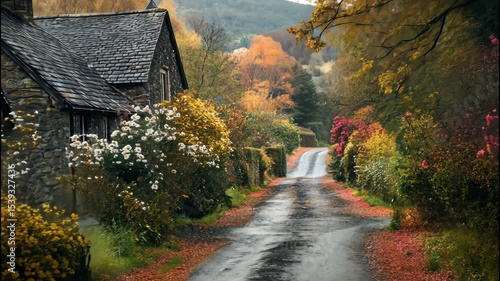 Peaceful countryside road lined with vibrant fall foliage and cozy homes on a crisp autumn morning. 