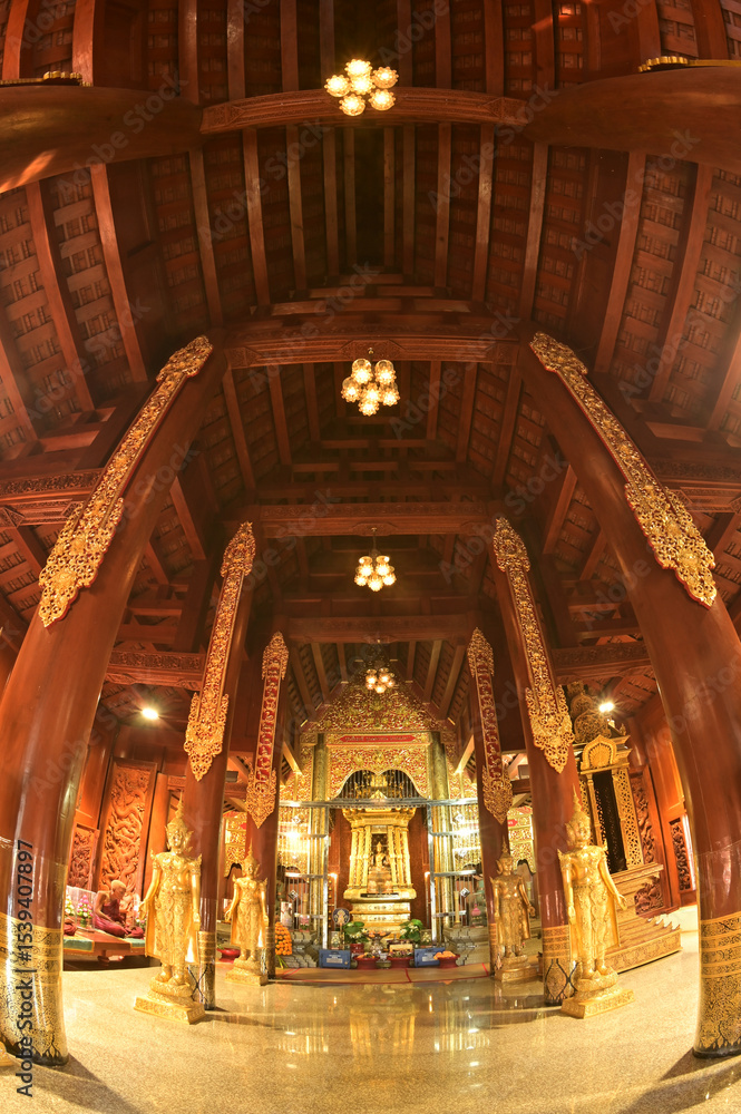 Obraz premium The statue of Phra Chao Pantan Buddha is enshrined in a teakwood chapel at Wat Den Sali Si Mueang Kaen temple or Wat Ban Den. Located at Cheng Mai Province in Thailand.