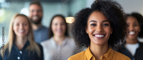 Diverse business team smiling and collaborating in a professional office environment