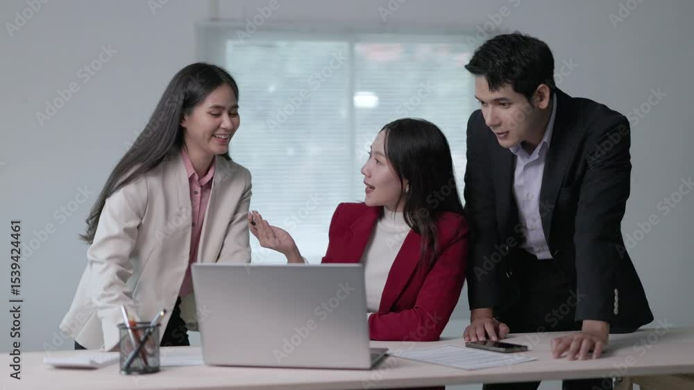 Professional business team collaborating, analyzing project strategy on laptop during strategic meeting in modern office workspace Professional business team collaborating, analyzing project strategy on laptop during strategic meeting in modern office workspace