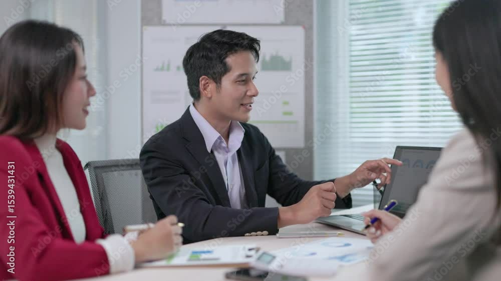 Professional business teammates analyzing financial data collaboratively, reviewing laptop metrics during strategic office meeting Professional business teammates analyzing financial data collaboratively, reviewing laptop metrics during strategic office meeting