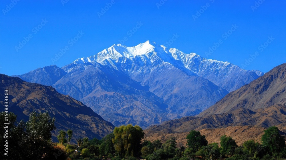 Fototapeta premium Majestic mountain range with snow-capped peak