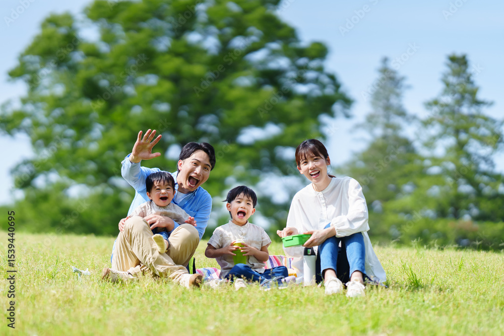 Fototapeta premium 公園でピクニックする四人家族